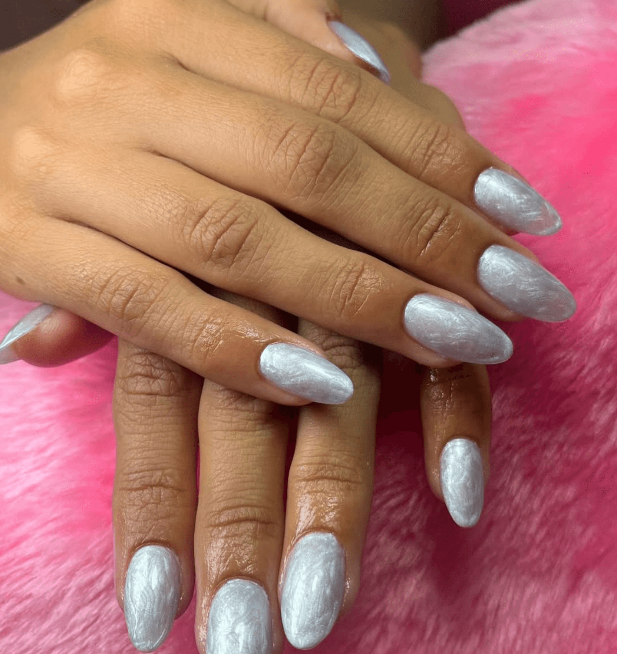 White nails with silver shimmer and crinkle texture in a pearl finish